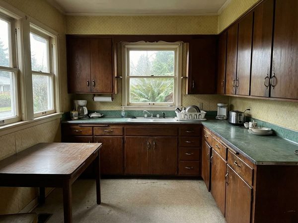 Kitchen with worn cabinets before refinishing